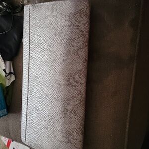 Grey faux snakeskin clutch.
